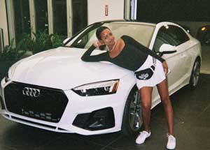 Kelly Stamps with her car Audi